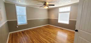 Large Master bedroom with wood flooring, and ceiling fan