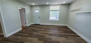 Family rm entrance featuring dark hardwood / wood-style flooring