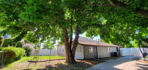 View of back of home with central AC