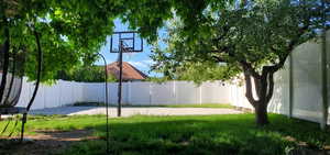 View of yard featuring basketball hoop