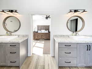 Master bathroom with vanity, ceiling fan, and hardwood / wood-style floors