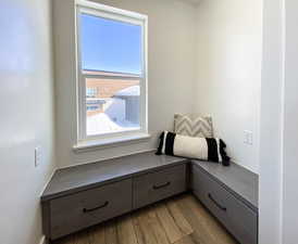 Window seating area. Living area featuring hardwood / wood-style flooring