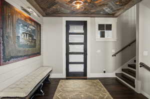 Foyer entrance featuring wooden ceiling and dark hardwood / wood-style floors