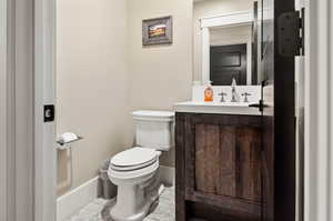 Bathroom featuring tile floors, toilet, and vanity