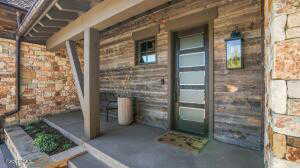 View of exterior entry with covered porch