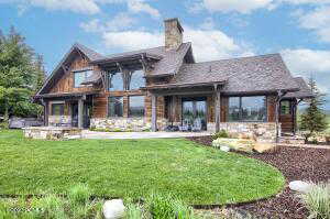 Rear view of property with a patio and a yard