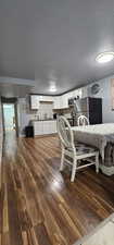 Dining space featuring hardwood / wood-style flooring and a textured ceiling