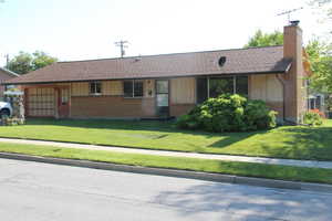 Ranch-style home with a front lawn