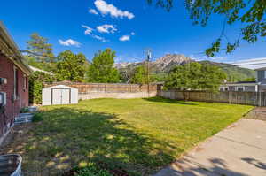 View of yard featuring a shed and a mountain view