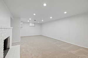 Unfurnished living room with carpet floors and a fireplace