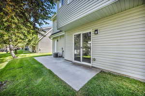 View of yard featuring a patio and central AC unit