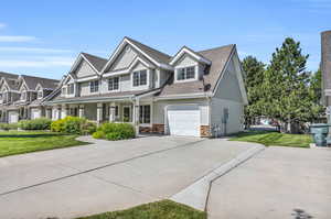 View of front of house featuring a garage and a front yard