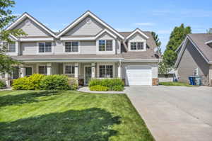 View of front of home with a garage and a front yard