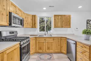 Kitchen featuring sink, light hardwood / wood-style flooring, and stainless steel appliances