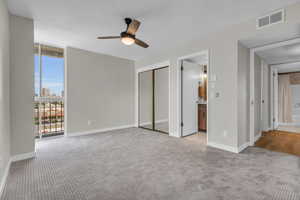 Primary bedroom has natural light and great view of downtown Salt Lake. Closet organizers are present.