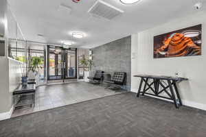 Secure building front lobby with modern furnishings greets you as you enter the building.