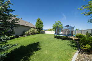 View of yard featuring a trampoline