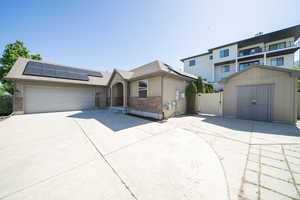 View of front of house with a garage and solar panels