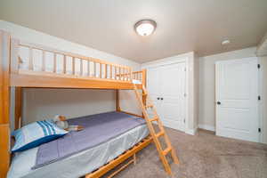 Carpeted bedroom featuring a closet