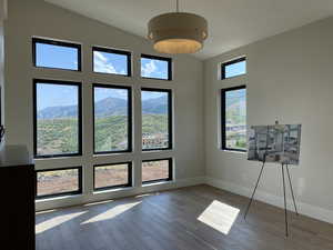 Interior space featuring plenty of natural light, a mountain view, lofted ceiling, and light hardwood / wood-style flooring