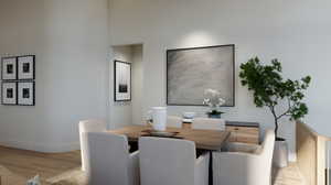 Dining area with a high ceiling and light hardwood / wood-style flooring