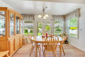 Dining room featuring light hardwood / wood-style floors and a chandelier