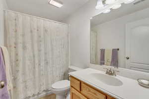 Bathroom with tile floors, vanity, and toilet