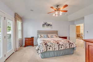 Bedroom with light carpet, access to outside, and ceiling fan