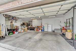 4/5 Car garage with a workshop area, and a garage door opener