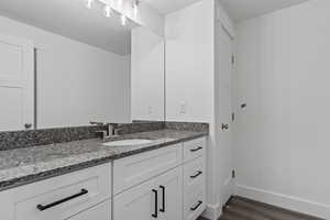 Bathroom featuring wood-type flooring and vanity