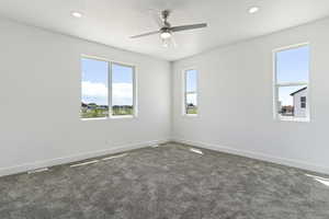 Empty room featuring carpet and ceiling fan