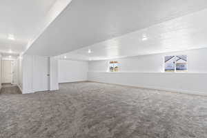 Bonus room featuring a textured ceiling, a healthy amount of sunlight, and carpet floors