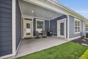 Exterior space with a porch, central air condition unit, and grilling area