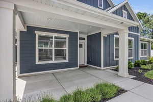 Doorway to property with covered porch