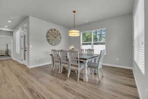 Dining room with light hardwood / wood-style floors