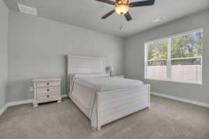 Bedroom featuring ceiling fan and light colored carpet