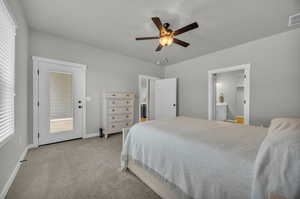 Carpeted bedroom featuring ensuite bathroom, ceiling fan, access to exterior, and multiple windows