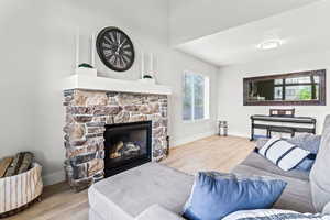 Front Entry Living room with a stone fireplace