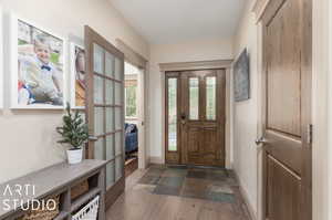 Foyer entrance with dark tile floors