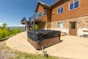 Exterior space featuring a deck, grilling area, and a hot tub