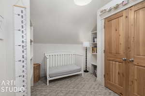 Bedroom featuring light colored carpet