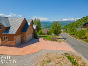 View of side of property featuring a garage and a mountain view
