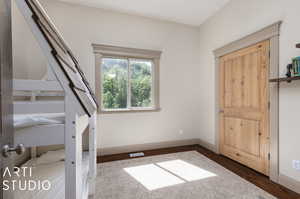 Unfurnished bedroom with dark wood-type flooring