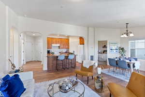 Living room featuring an inviting chandelier and light hardwood / wood-style flooring