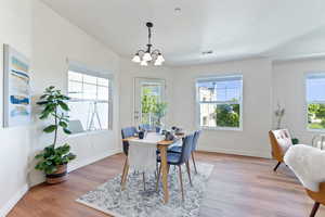 Dining room with a notable chandelier and light wood-type flooring