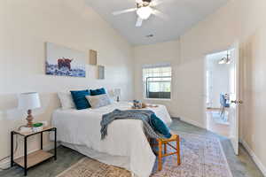 Bedroom with lofted ceiling, ceiling fan, and hardwood / wood-style floors