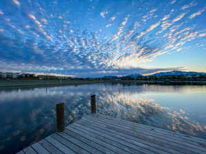 Dock area featuring a water and mountain view