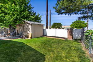 View of yard featuring a storage unit