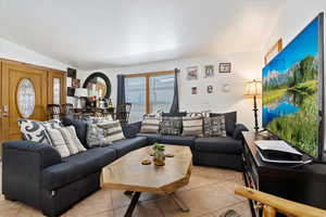 Tiled living room with vaulted ceiling