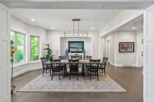 Dining space with a chandelier and dark hardwood / wood-style flooring